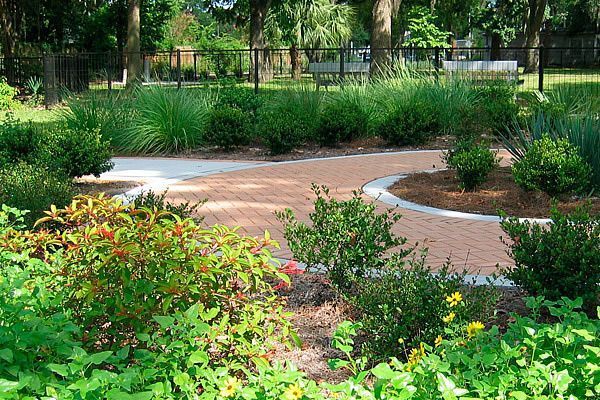 Native planting bed with paver walkway installed by Wildscape Designs